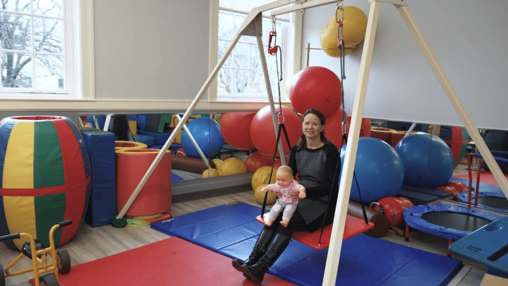 Clinical setting therapy pediatric space: pediatric swing, toys, mats and exercise equipment